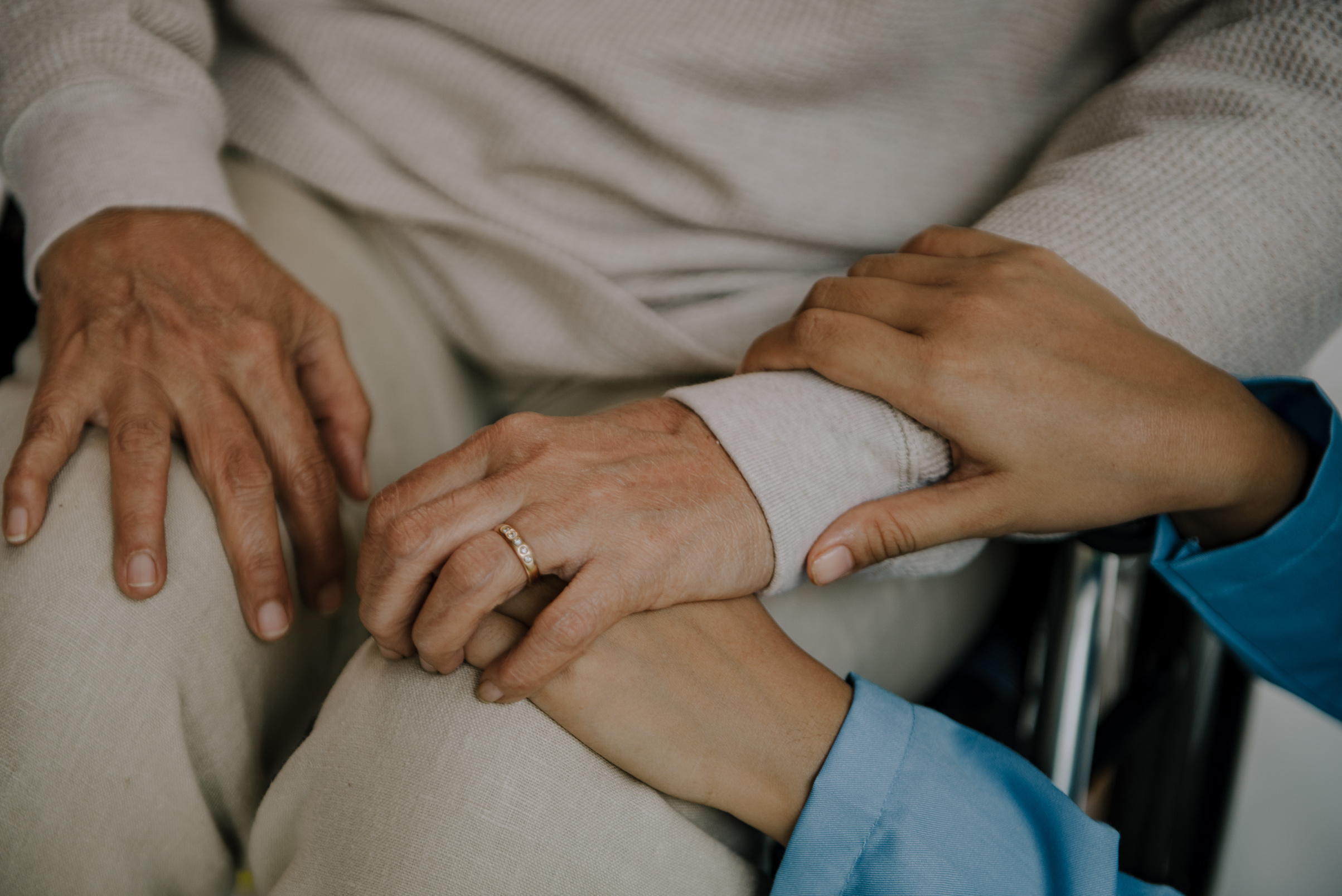Nurse Holding the Hand of an Elderly Woman